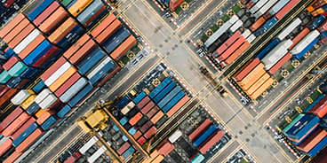 An image of a lot of containers at a harbour.